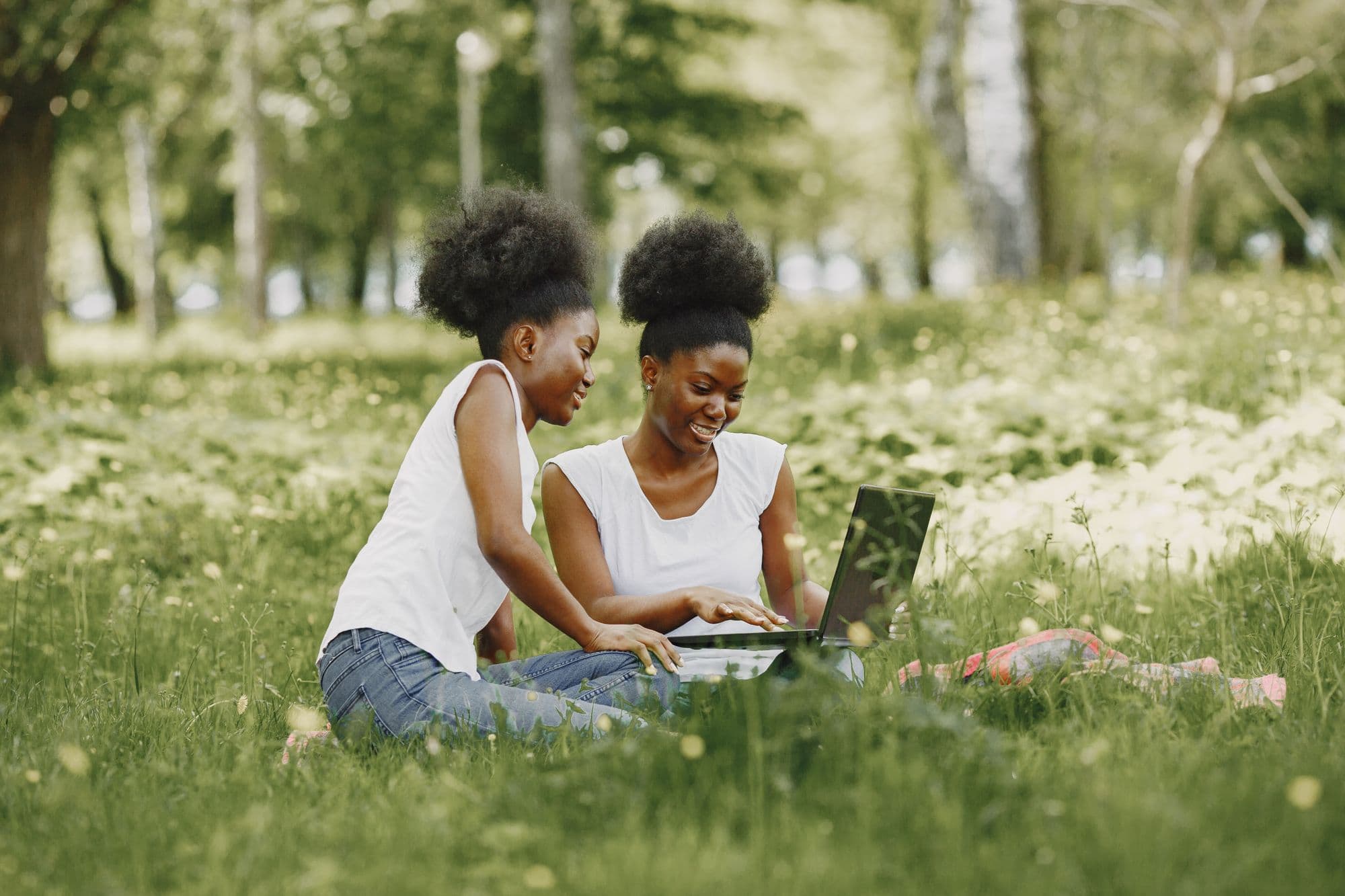 Two students working together on a laptop